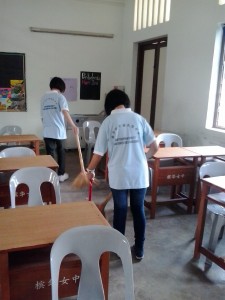 Members sweaping the floor.