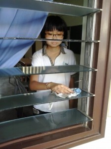 This member cleans the window pain of A3 class room.