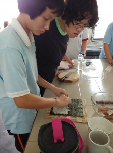 Some of the students making the sushi roll.